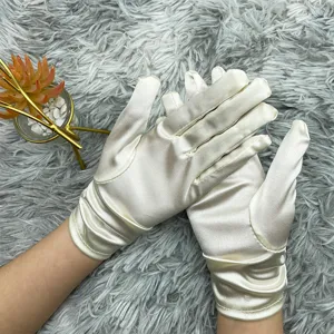 Close-up of elegant satin gloves featuring gathered wrist design for wedding dress accessory.