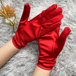 Detail view of vibrant red satin gloves, smooth glossy texture and elegant bridal accessory look.