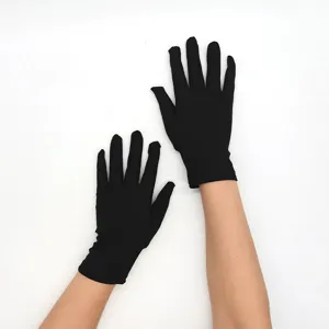 Detailed view of women's short black milk silk stretch gloves for stage performance and daily wear.