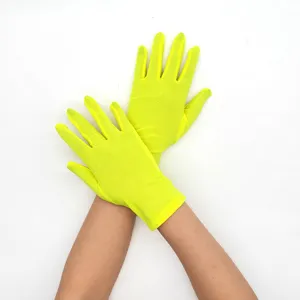 Detail shot of women short fluorescent yellow milk silk stretch gloves for stage show.