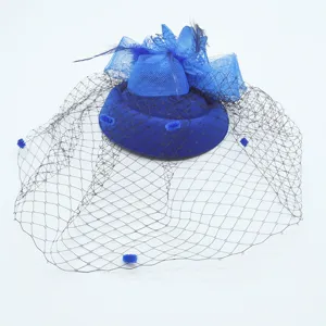Detail view of royal blue fascinator hat with mesh veil and feathers for vintage tea parties.