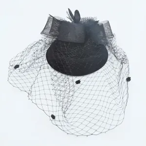 Black vintage pillbox hat with mesh veil, elegant bow and feathers for bridal and party.