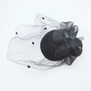 Close-up detail of black vintage feather mesh fascinator hat, elegant bridal headwear style.