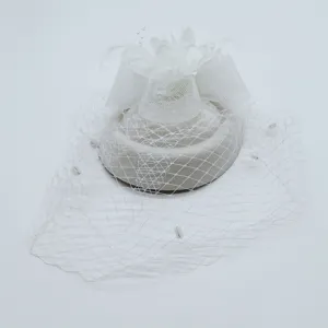 White vintage fascinator hat with veil feathers and flower for wedding party races.