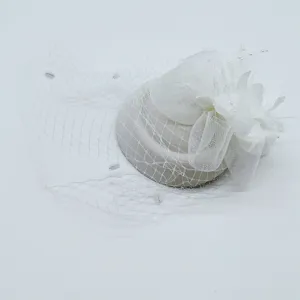 White vintage fascinator hat with mesh veil, floral and feather details for wedding prom.