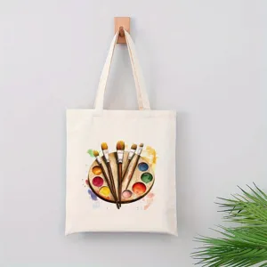 Detalle de bolso tote de lona con diseño de paleta y pinceles de acuarela coloridos para uso diario