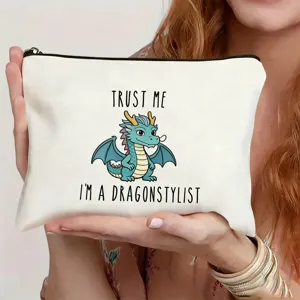 Detail view of white canvas cosmetic pouch with cute dragon print and zipper closure.