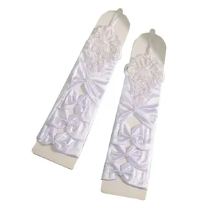 White long wedding gloves with delicate lace appliques and bow pearl details for elegant brides.