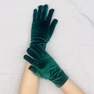 Detailed view of short stretch green velvet gloves, soft texture and exquisite close-up.