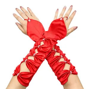 Close-up detail of red satin hollow-out fingerless wedding gloves with pearl beads.