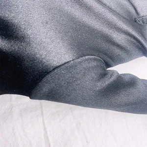 Close up view of short stretch satin glove showing fine fabric texture and neat stitching details.