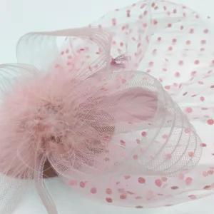 Pink mesh feather fascinator detail, vintage 1920s style hair accessory close-up view.