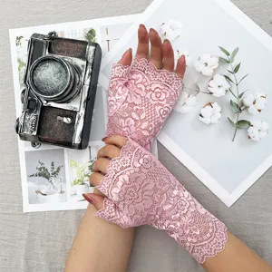 Pink lace fingerless gloves for women, summer sun protection floral lace driving gloves detail.