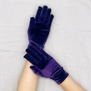 Detailed close-up view of short stretch velvet gloves in deep purple for winter party wear.