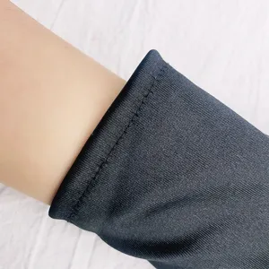 Black satin short stretch gloves detail view, elegant fabric texture and smooth finish.