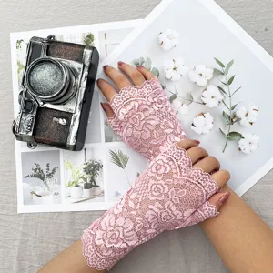 Detailed view of women half finger lace floral gloves, summer outdoor sun protection gear.
