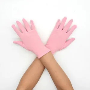 Detail view of women short pink milk silk stretch gloves for stage performance and sun protection.