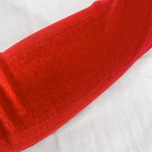 Red velvet fabric texture detail close-up for vintage opera gloves, soft and comfortable.