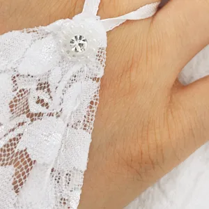 Lace glove detail view featuring delicate floral pattern and sparkling crystal rhinestone decor.