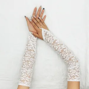 Close-up detail of white lace long gloves, featuring delicate floral patterns and finger loop.