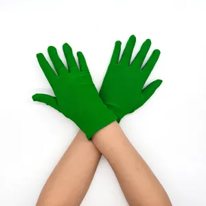 Close-up of bright green stretch gloves detail, soft fabric texture for comfortable wear.