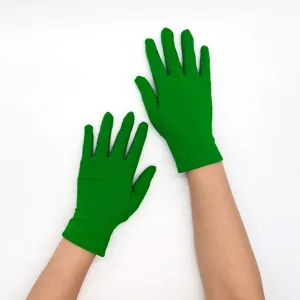 Close-up detail view of women's green stretch gloves, showing fabric texture and finger fit.