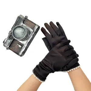 Elegant black stretch satin evening gloves with delicate pearl trim for weddings and formal events.