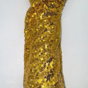 Gold sequin long gloves detail view, shining reflective surface for stage and party wear.