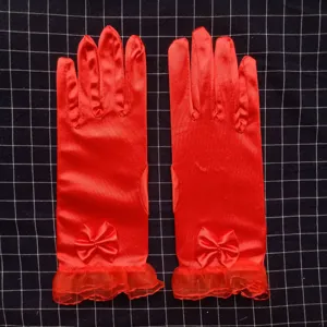 Gants de mariage en satin rouge détail avec nœud et volants, accessoire de costume élégant.