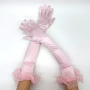 Pink satin long gloves detail featuring delicate tulle ruffles and pearl accents for party wear.