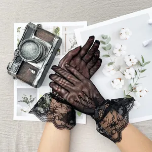 Close-up of black fishnet lace gloves featuring delicate ruffles and bowknot details.