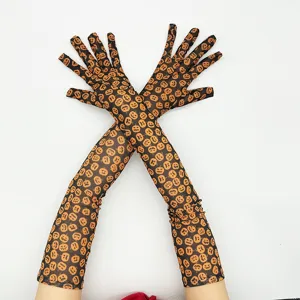 Halloween long black mesh gloves with orange pumpkin print, party costume accessory.