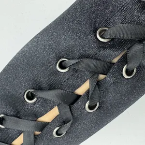 Détail de gants en satin noir à lacets, œillets métalliques, style cosplay gothique.