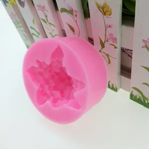 Detailed view of pink silicone mold with intricate flower texture for DIY baking and crafts.