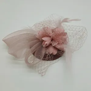 Pink feather mesh fascinator 1920s hair accessory detail view showing floral bow and veil.