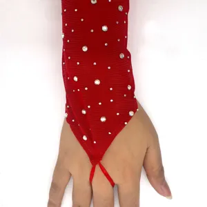 Detailed view of red mesh finger loop glove decorated with glittering rhinestones.