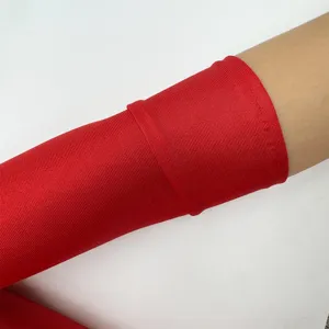 Close-up detail of the vibrant red stretch satin long glove fabric and fine ribbed texture.