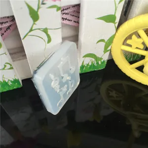 Detailed view of translucent silicone mini music note epoxy resin mold for DIY crafts.
