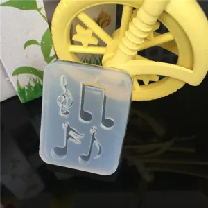 Silicone musical note mold detail showing cavity shapes for handmade DIY resin earrings and pendants.