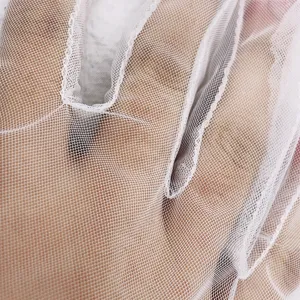 Detailed view of white mesh lace sun protection gloves, showing fine mesh texture.