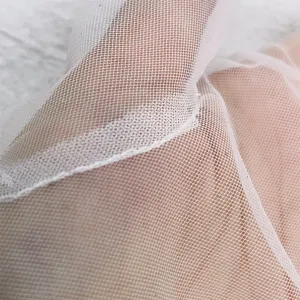 Detail view of white mesh sun protection gloves, showing fine fabric texture and neat seams.