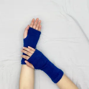 Detailed view of soft blue knitted fingerless gloves, offering cozy warmth and dexterity for winter.