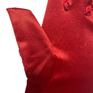 Nahaufnahme Detail roter Satin Hochzeitshandschuhe, glatte Stofftextur für Fotografie.