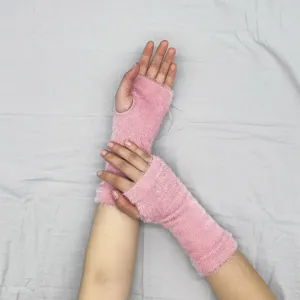 Pink fuzzy fingerless knit gloves detail, warm winter wrist arm warmers for women men writing.