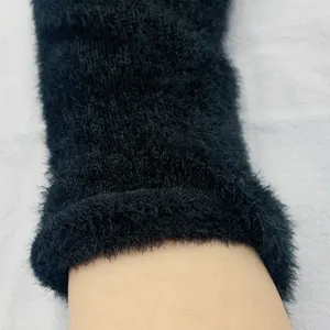 Closeup detail view of black fuzzy knit arm warmer glove, soft plush texture design.