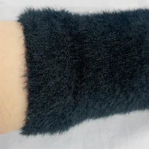 Detail view of black fuzzy winter half finger gloves, soft plush wrist warmers knit style.