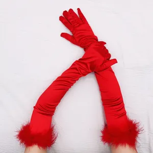 Detailed view of long red satin gloves with fluffy feather cuffs for vintage party and cosplay.