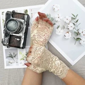 Detail shot of women's half finger lace gloves, delicate floral pattern, breathable fabric.