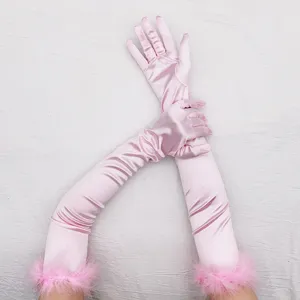 Close-up detail of the pink satin long gloves with faux fur cuff, vintage 1920s party style.