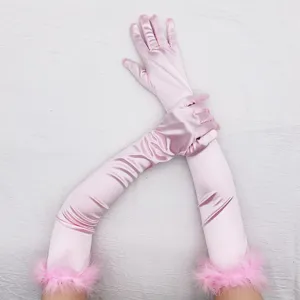 Pink long satin gloves detail featuring fluffy feather cuffs, elegant retro party accessory style.